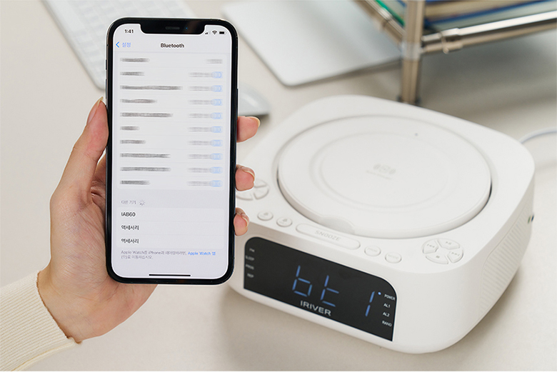 Close-up of a smartphone on the wireless charging pad of the IRiver IAB60